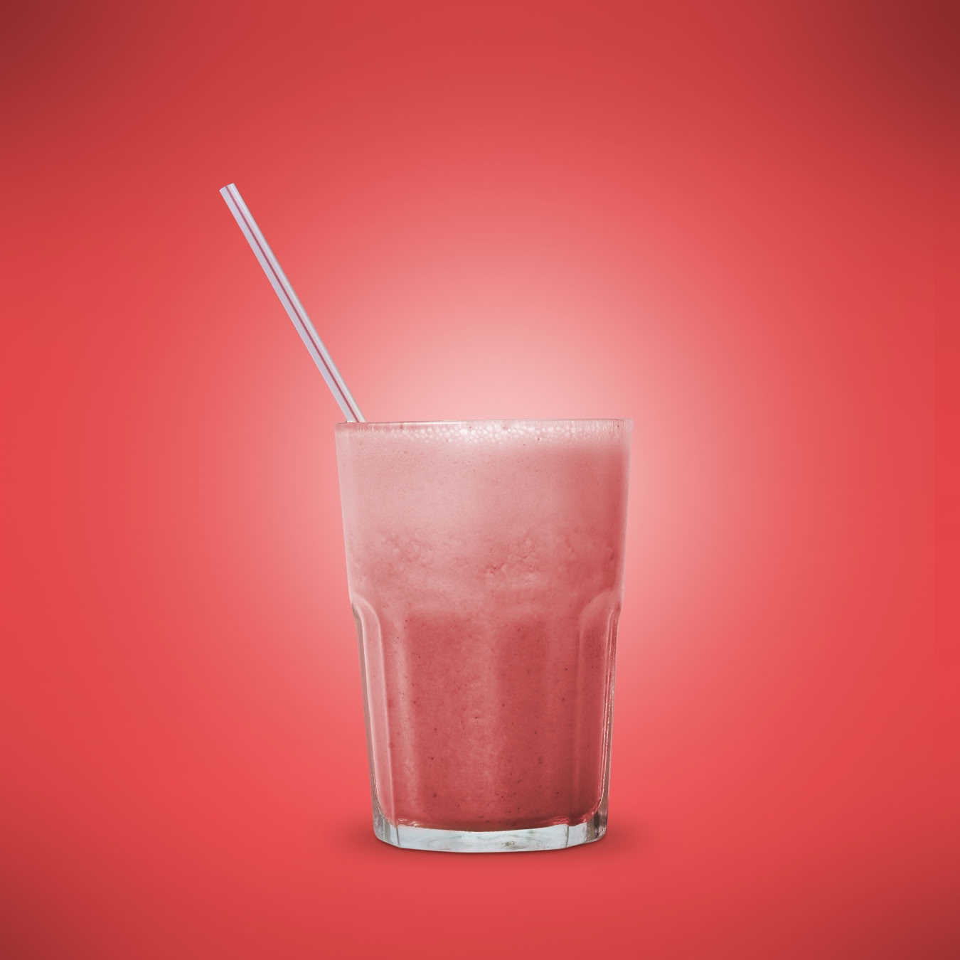 A stack of colorful books with a glass of milk on a draped fabric background.