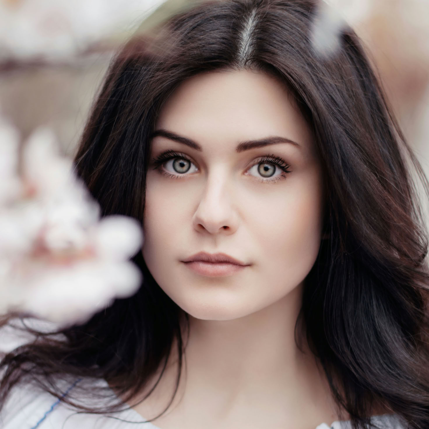 A young woman poses outdoors with floral accessories, showcasing elegance and style.